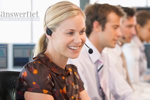 smiling female call center agent on line with other agents next to her