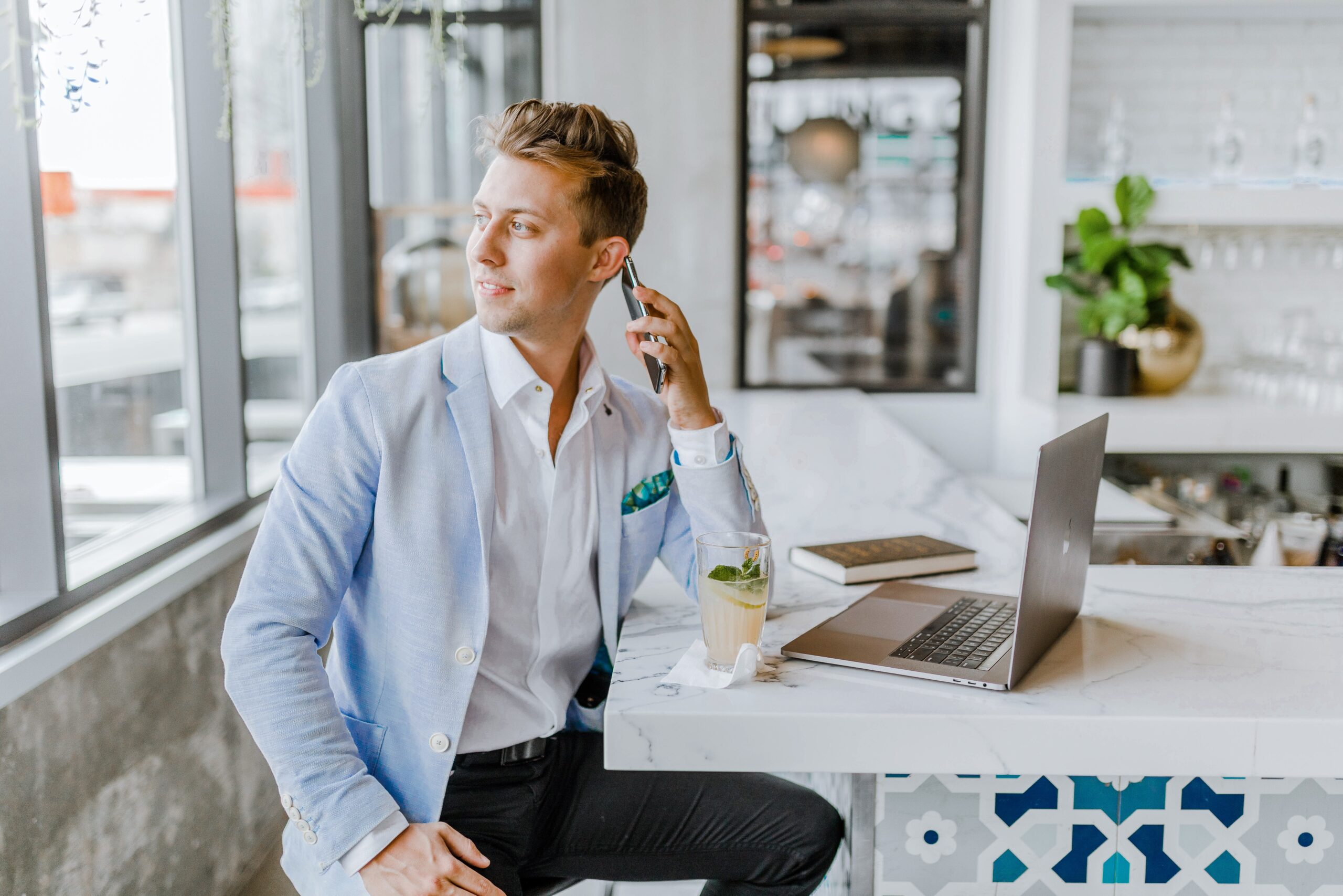 business man on phone looking out window