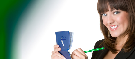 smiling woman writing on a pad