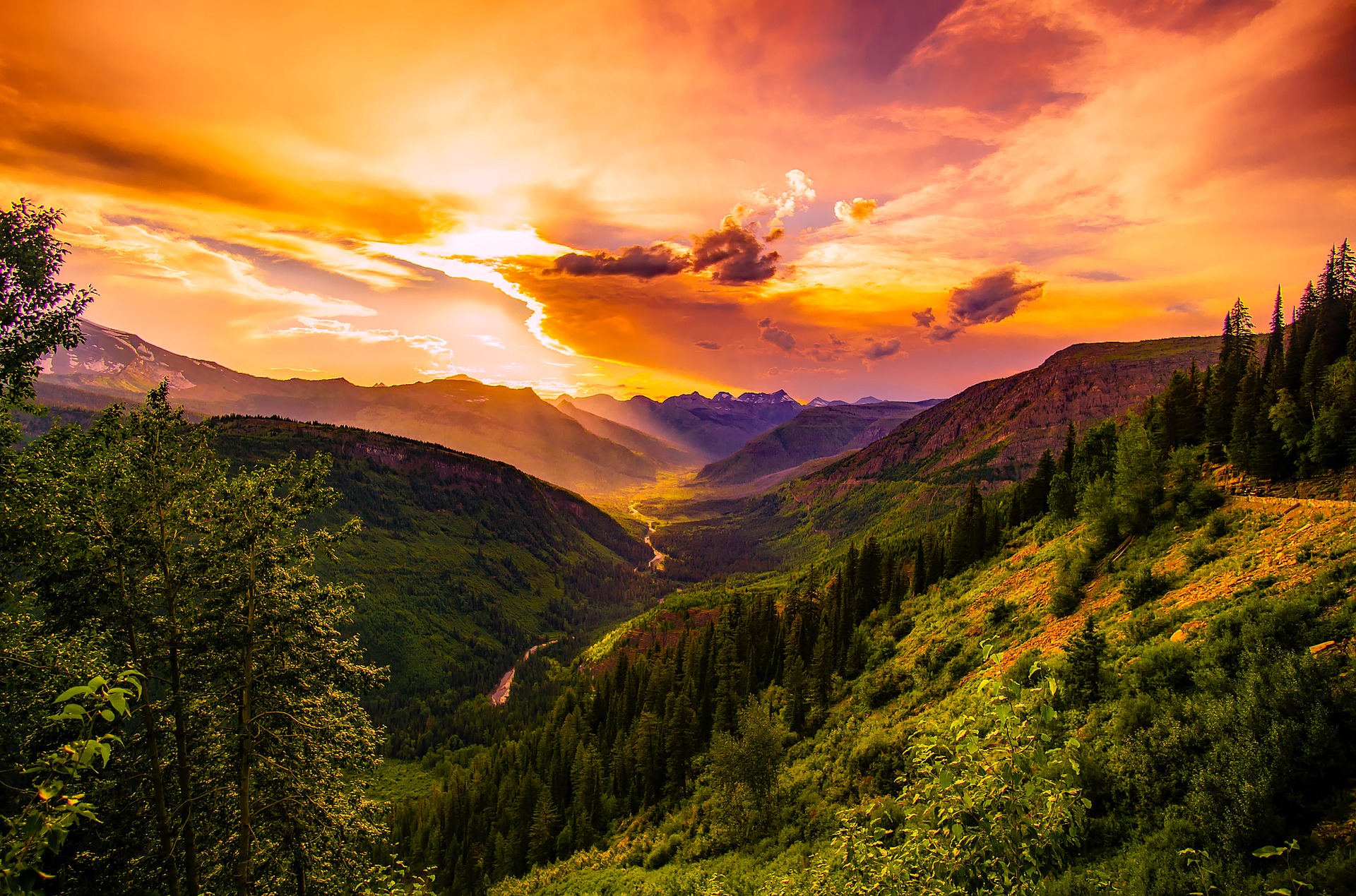 sun setting over a river and mountains in montana