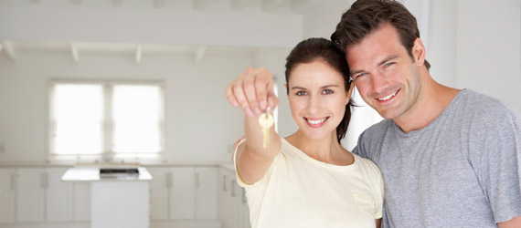 man and woman holding keys to a new home