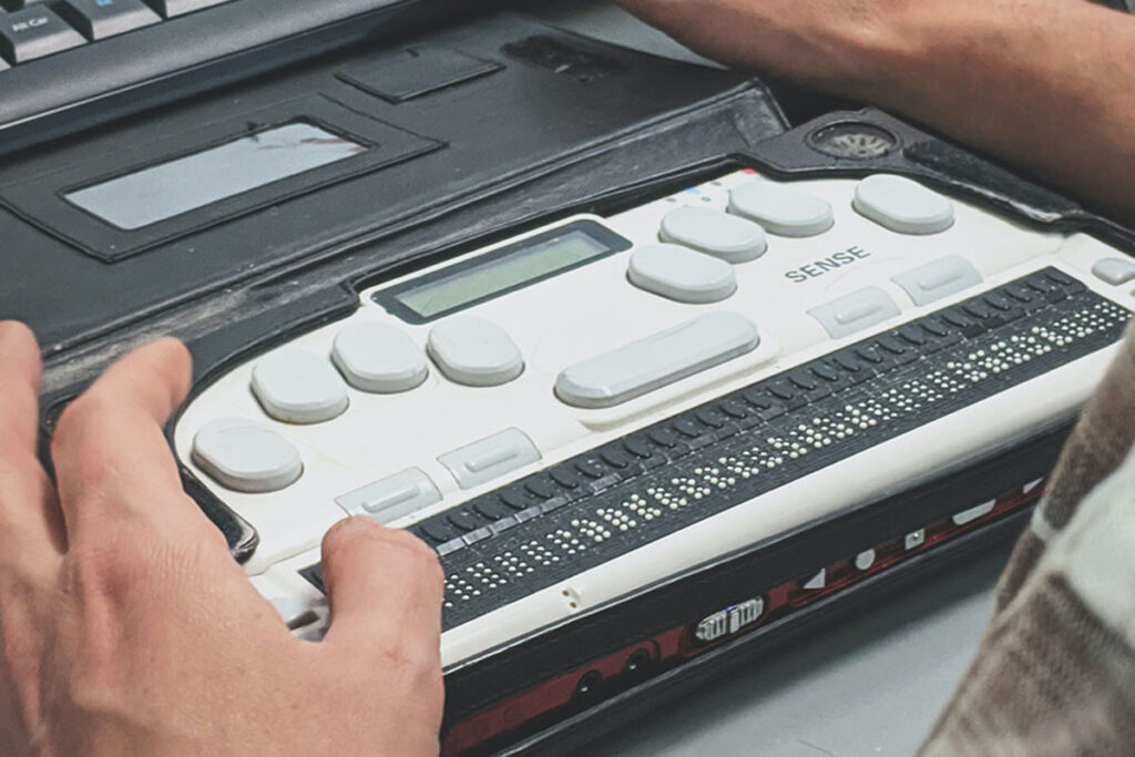 man using braille typewriter