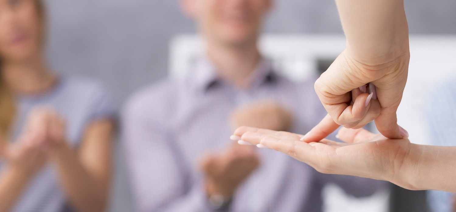 group of people using ASL to communicate