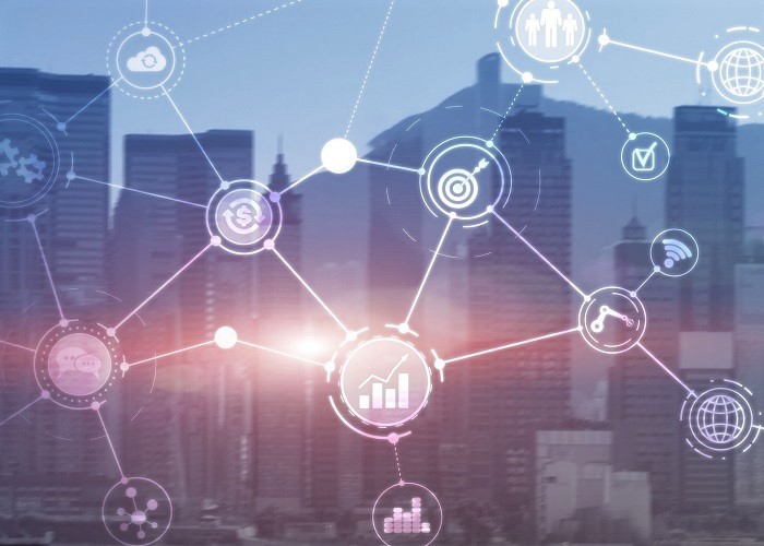city skyline with overlay of networking diagrams