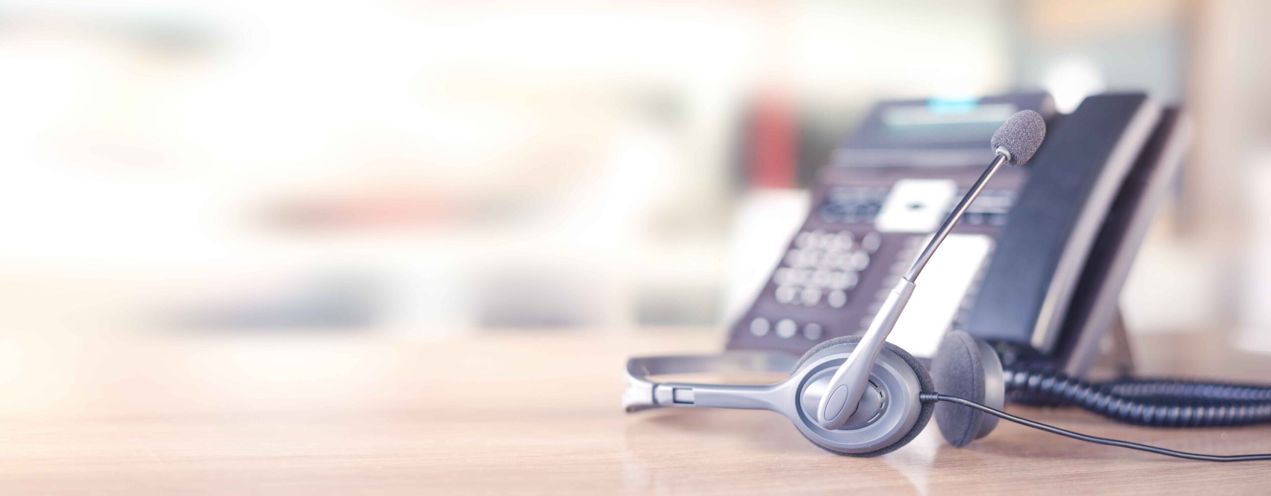 AnswerNet Canada - phone and headset laying on desk