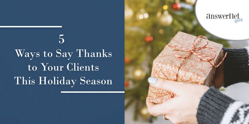 gifts - woman with sweater holding gift in front of tree